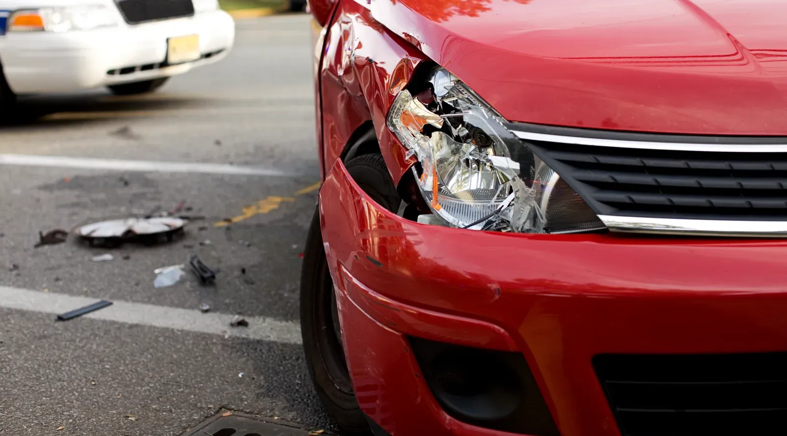Front-end paint and lamp damage from highway road debris