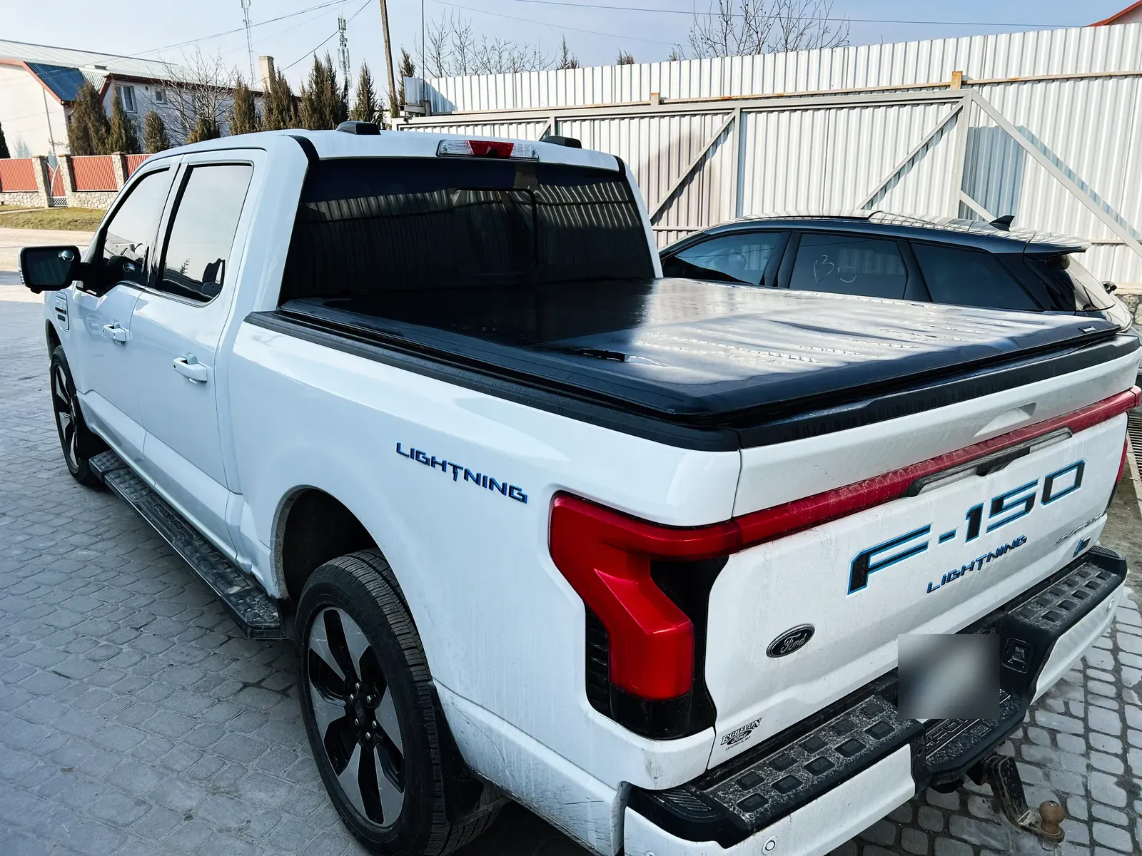 Pickup truck bed and tailgate being inspected for dent damage at a Savage, MN body shop