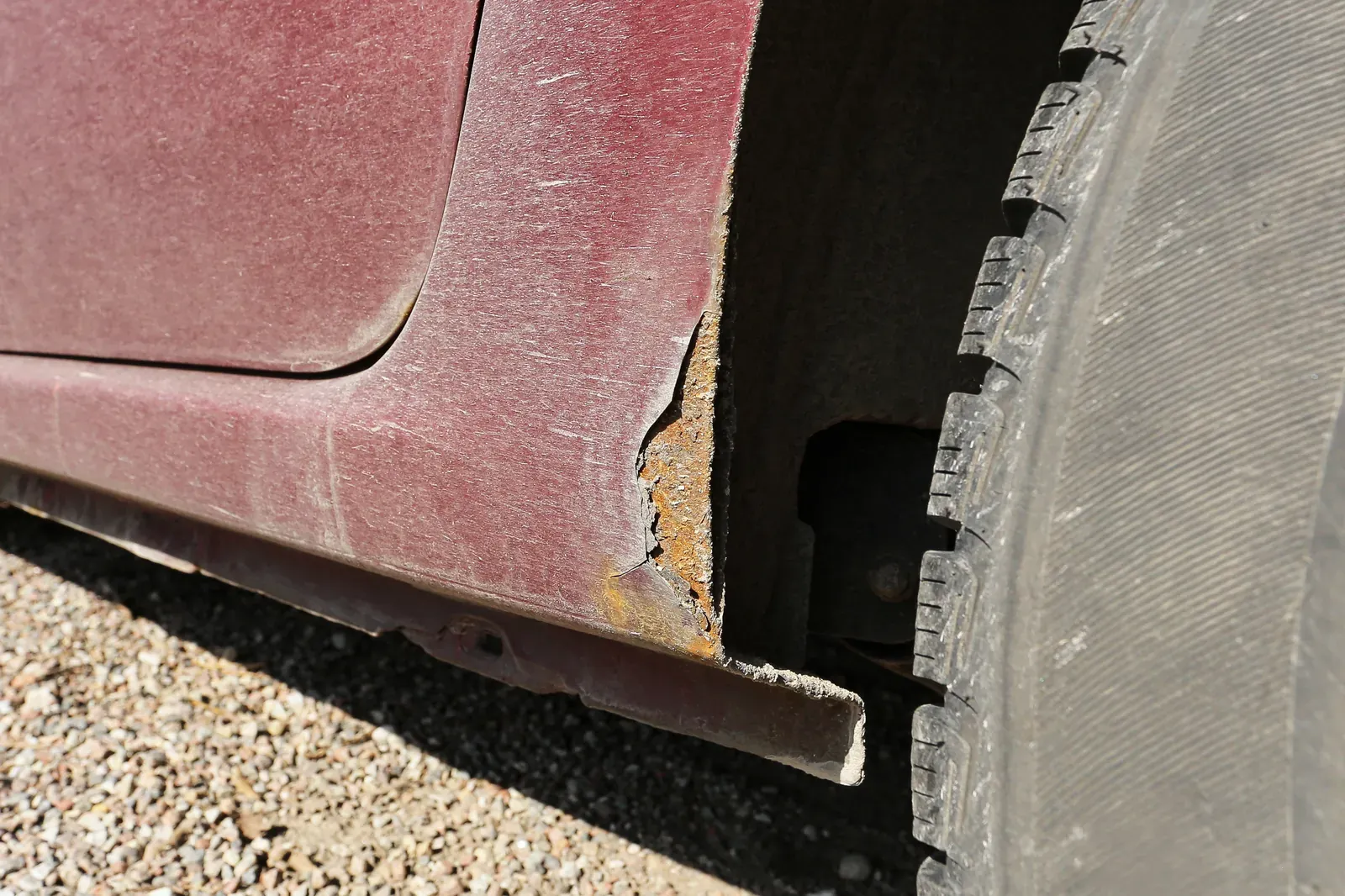 Corrosion bubbling through the finish on a rocker panel below the doors